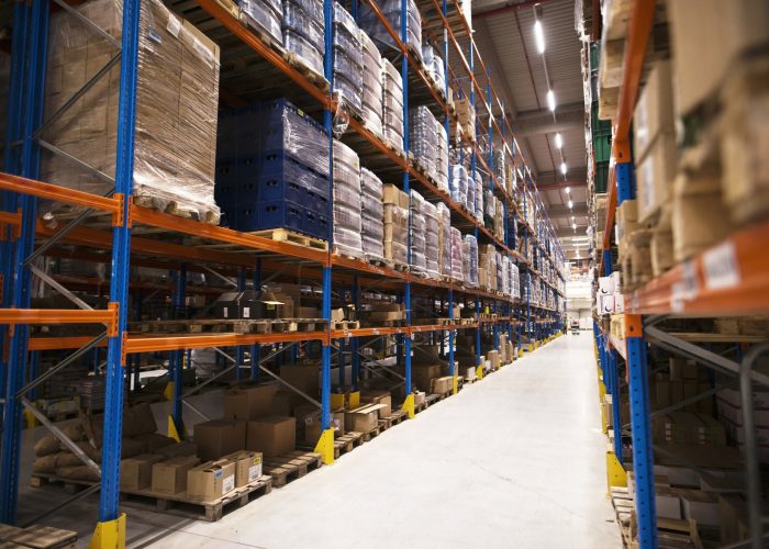 interior-large-distribution-warehouse-with-shelves-stacked-with-palettes-goods-ready-market
